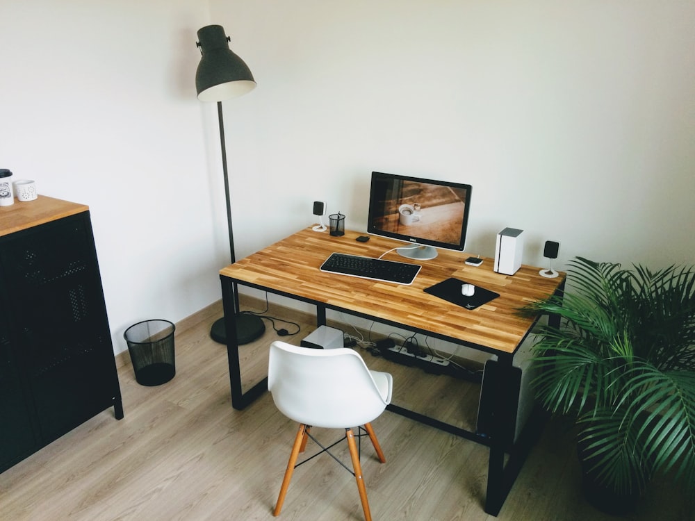 black flat screen computer monitor on brown wooden table