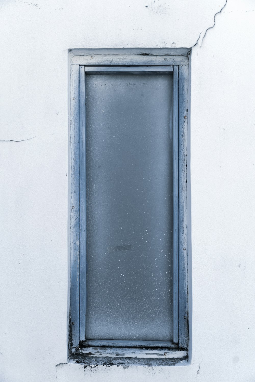 blue wooden window frame on white wall