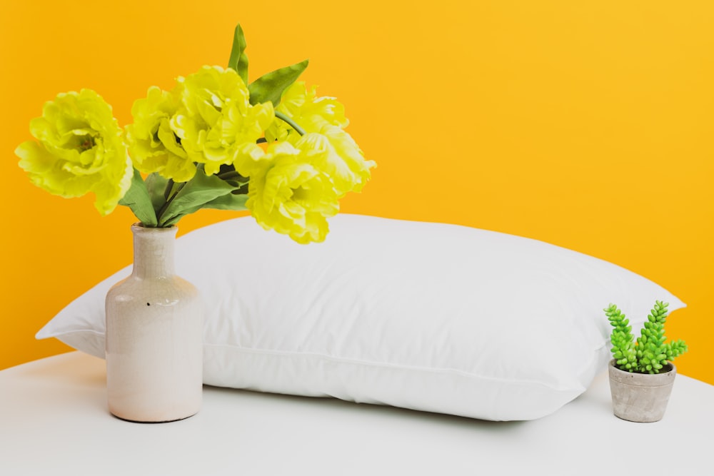 yellow flower in white ceramic vase