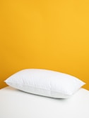 Close-up of a plush memory foam pillow resting on a flannel sheet set.