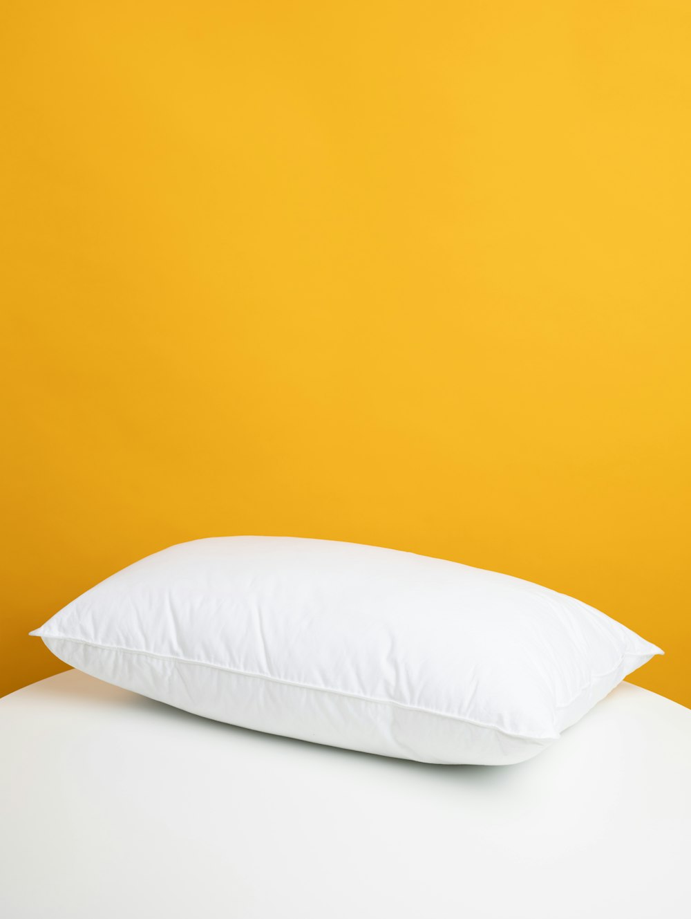 white pillow on white bed