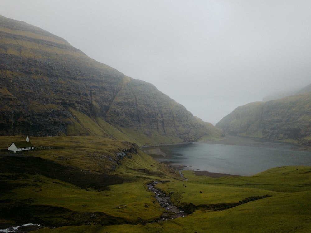 green mountains near body of water during daytime