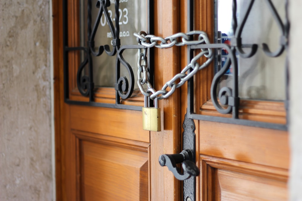 grey metal chain on brown wooden door