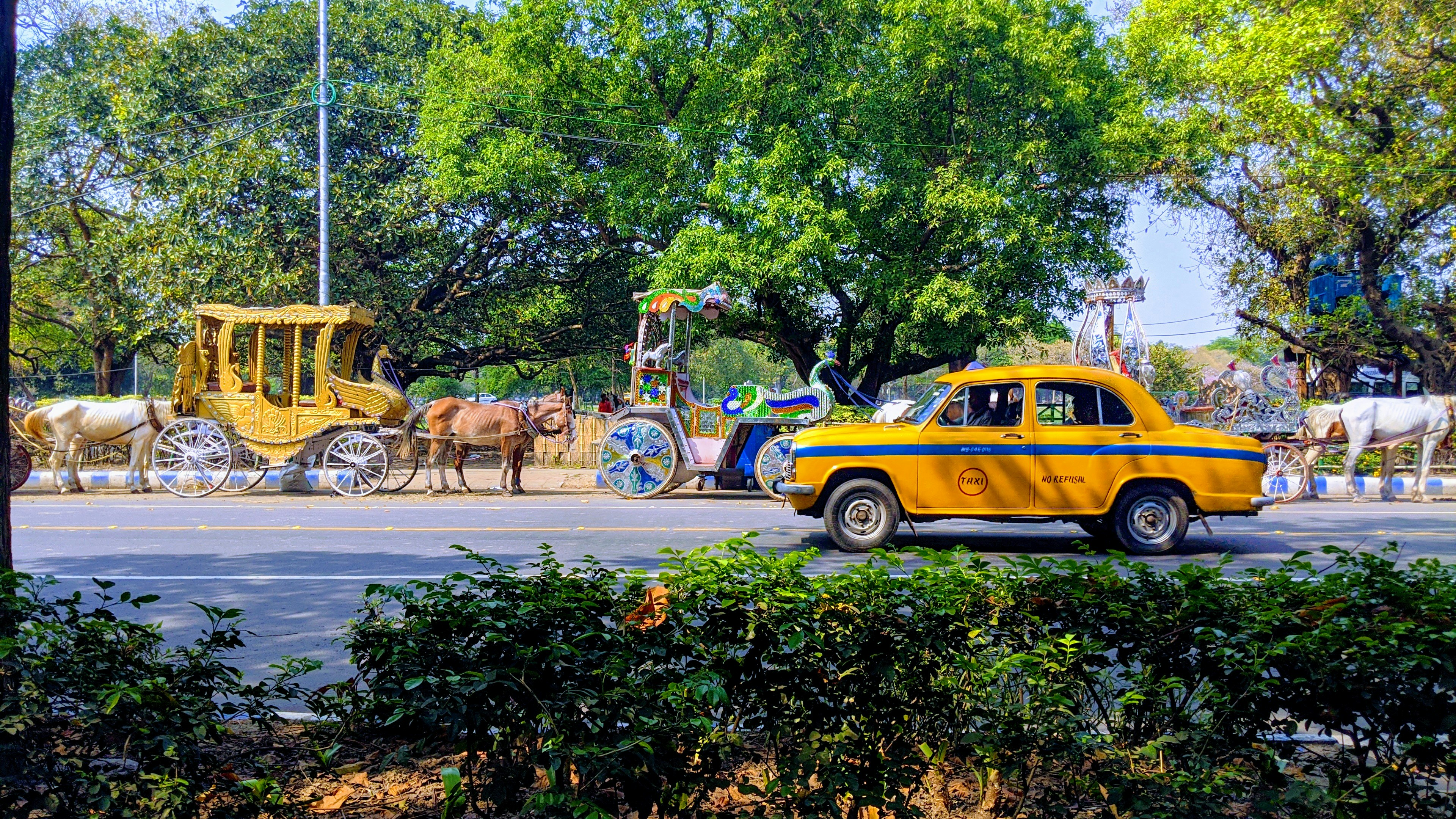 yellow and black vintage car on road during daytime