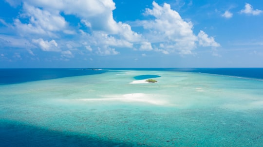 blue sea under blue sky and white clouds during daytime in Madivaru Finolhu Maldives