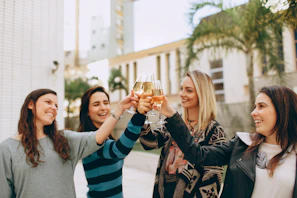 Group of women celebrating a successful business partnership outdoors by the sea.