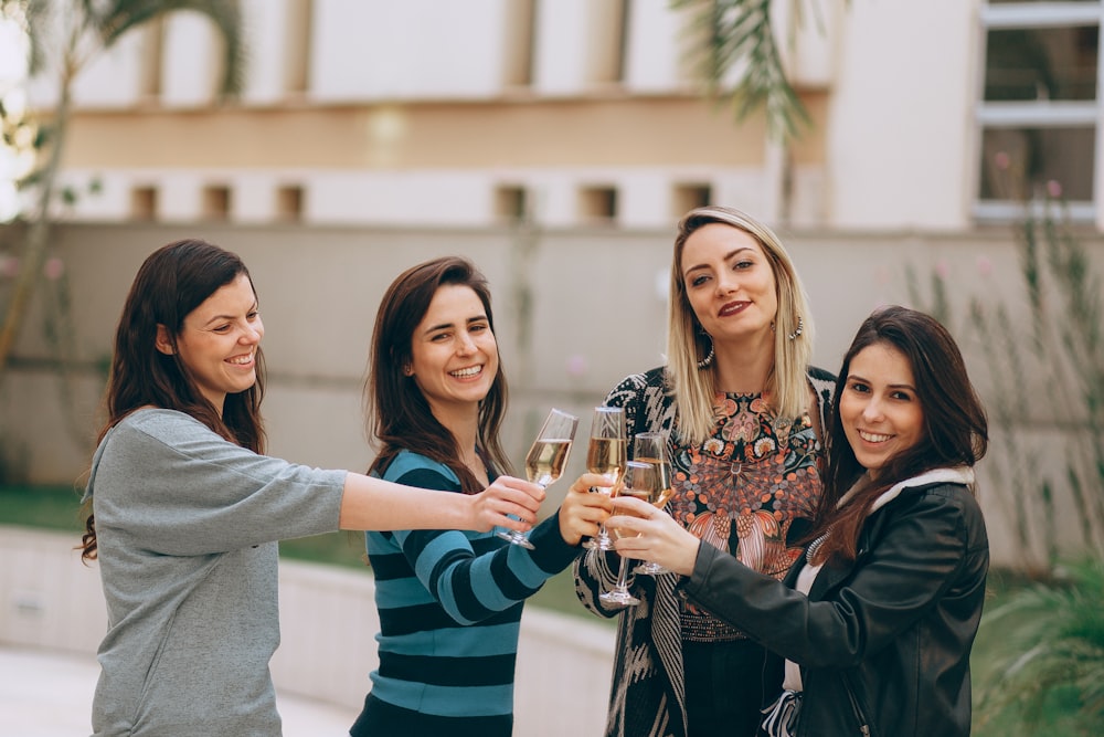 2 women smiling and holding drinking glass