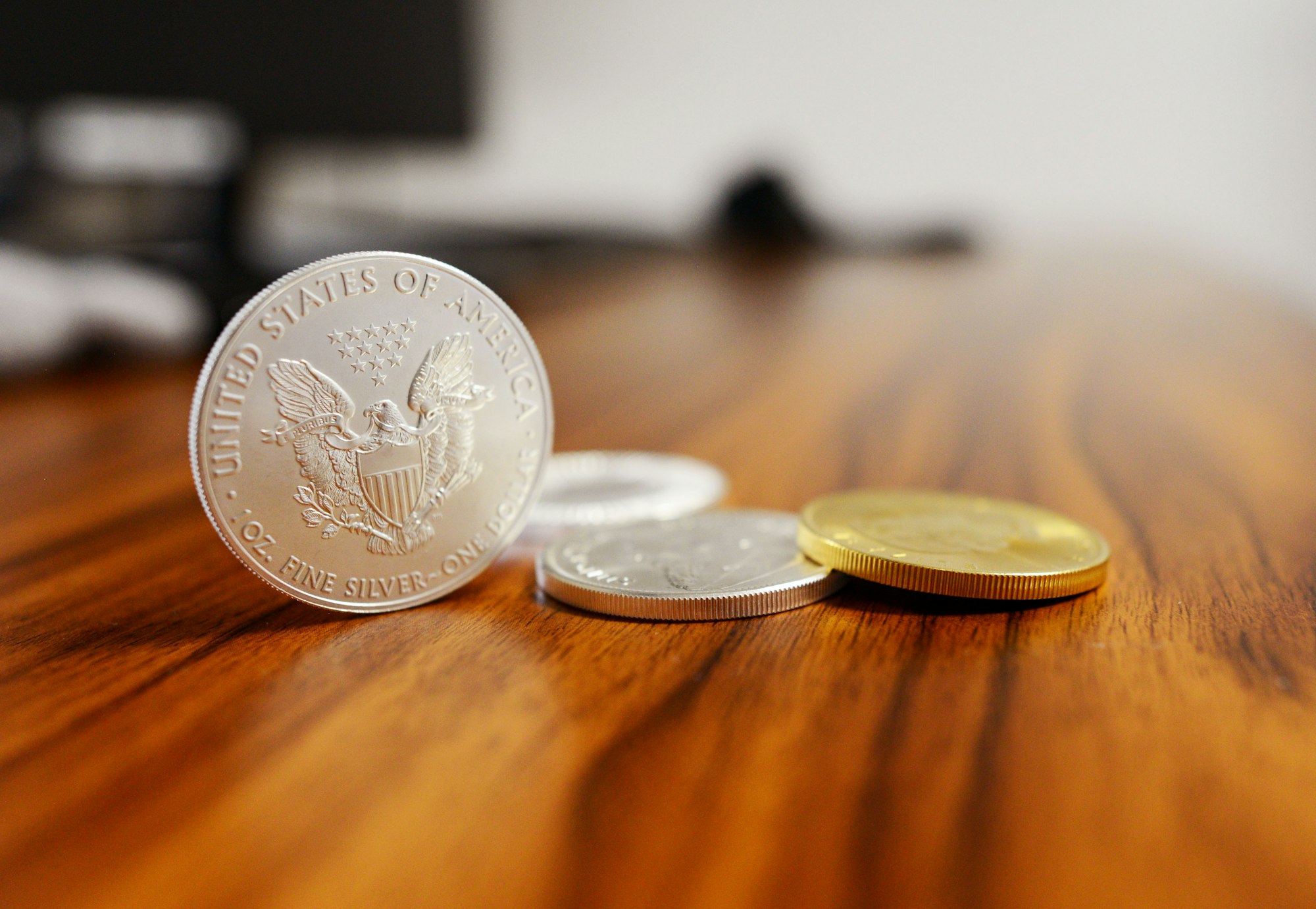 Coins on a table, one standing on edge.