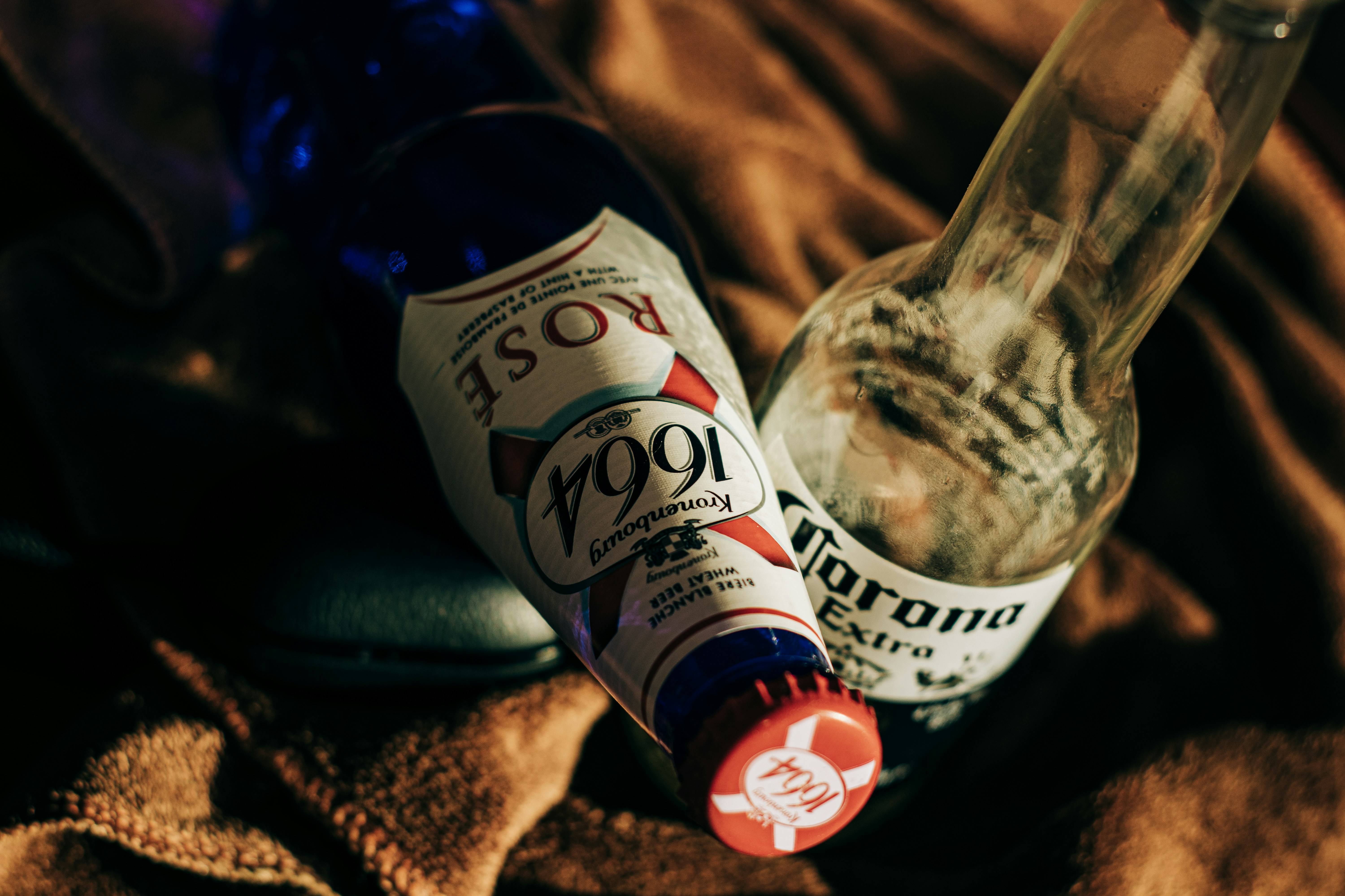 Two Clear Glass Bottles On Brown Textile Photo Free Beer Image On Unsplash