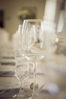 Elegant dining area set for a fine meal with sparkling glassware.