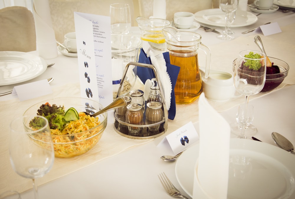 clear glass pitcher beside white ceramic plate on table