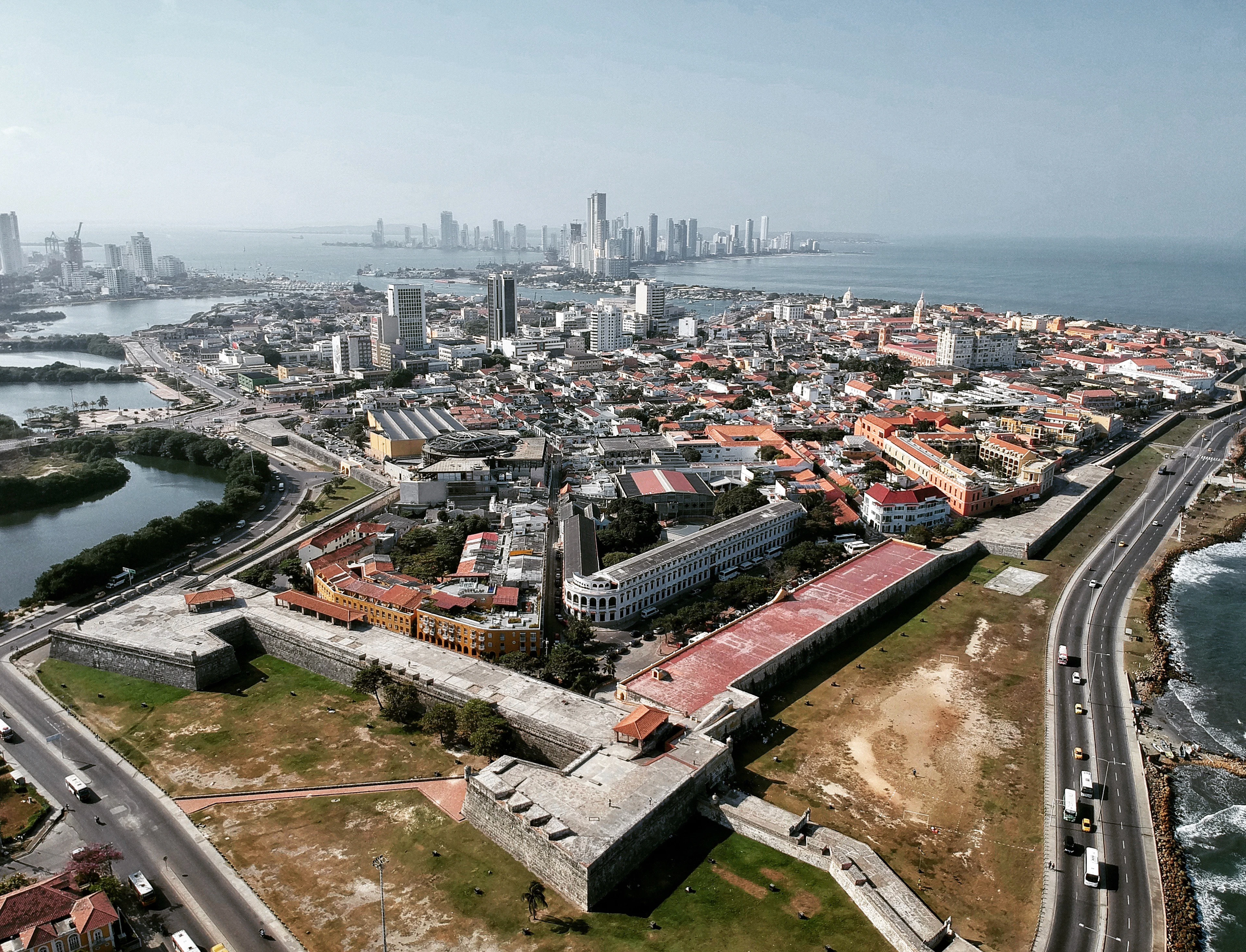 Aerial view of Cartagena with the stone bastions of Castillo San Felipe de Barajas in the foreground and the Bocagrande high-rises on the sea behind
