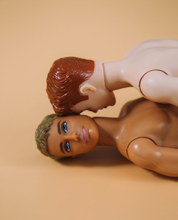 two brown haired male plastic toys