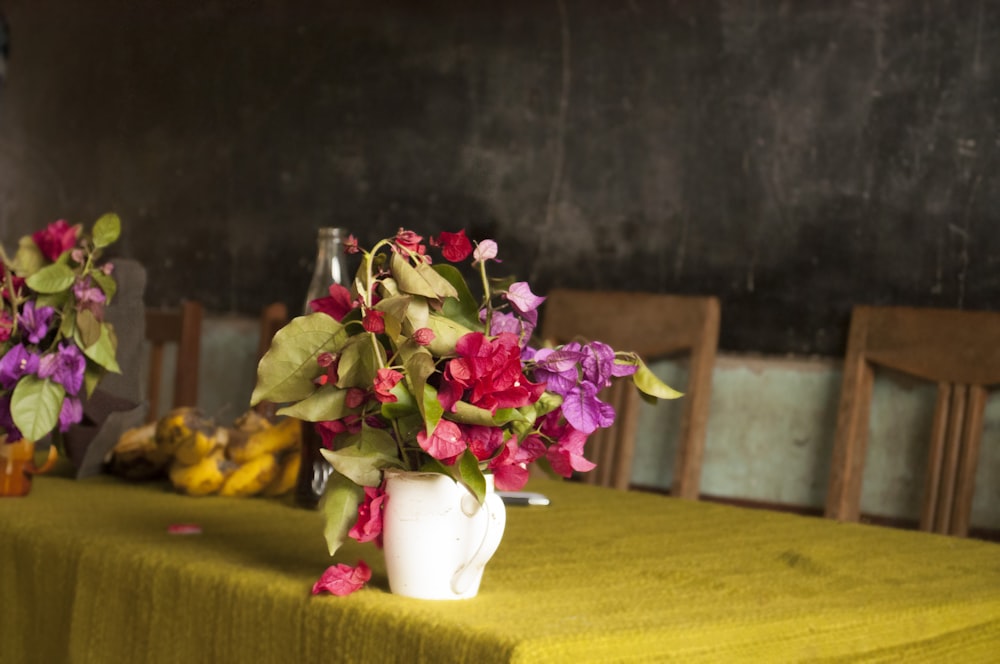 pink and yellow flowers in white ceramic vase