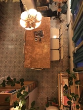 Cozy dimly lit dining area with olive green accents and golden details.