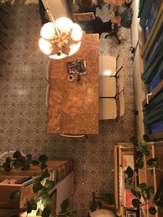 Cozy dimly lit dining area with olive green accents and golden details.