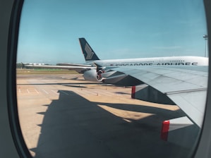 white and red airplane under blue sky during daytime