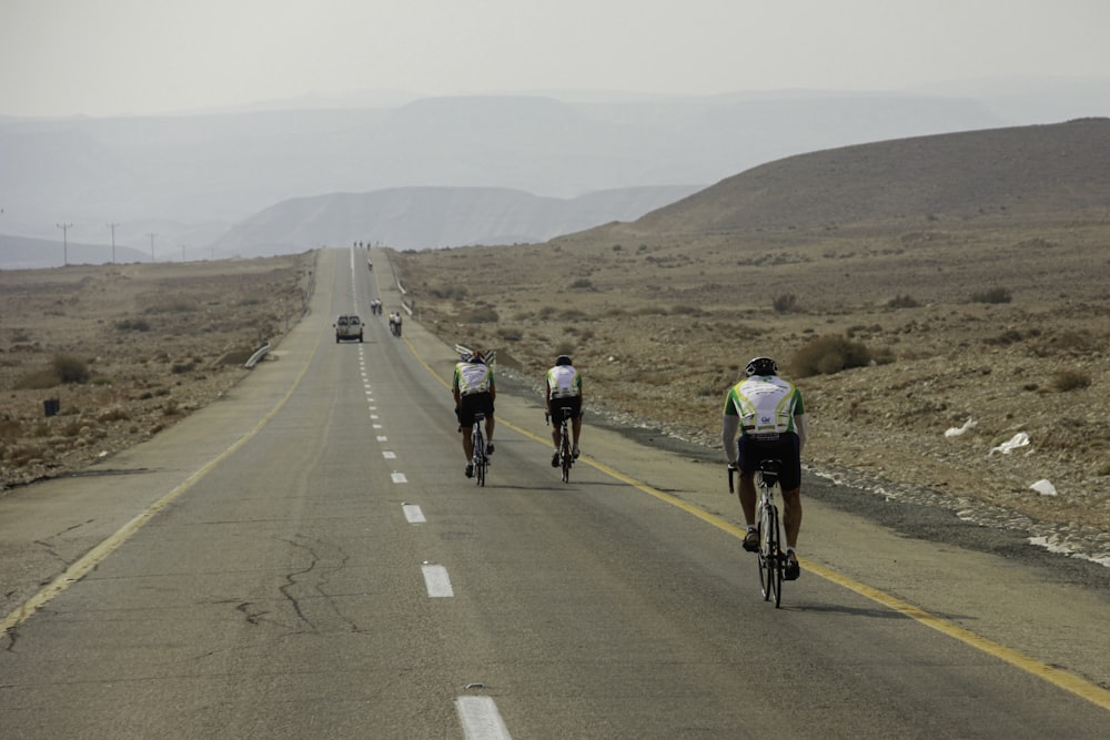 people riding bicycle on road during daytime