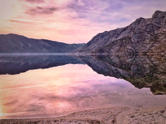 lake near mountain under cloudy sky during daytime in Risan Montenegro