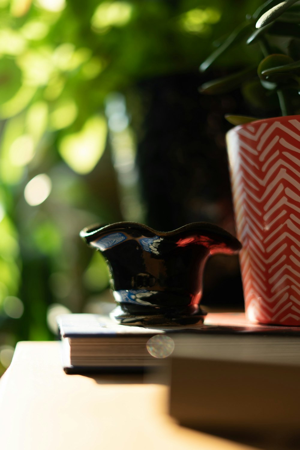 black ceramic pitcher on white wooden table