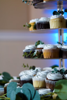white and brown cupcakes on blue steel rack