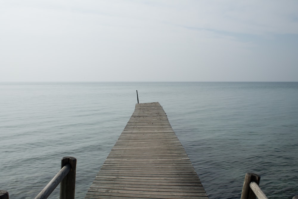 a long dock extending into the ocean