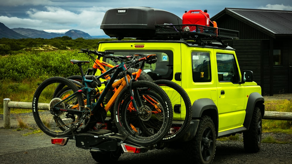 yellow and black motorcycle parked beside yellow suv