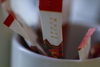 Close-up of white sugar bags arranged neatly in a storage area.