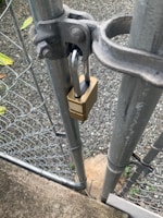 a padlock attached to a metal gate