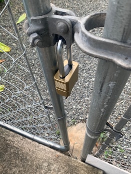 a padlock attached to a metal gate