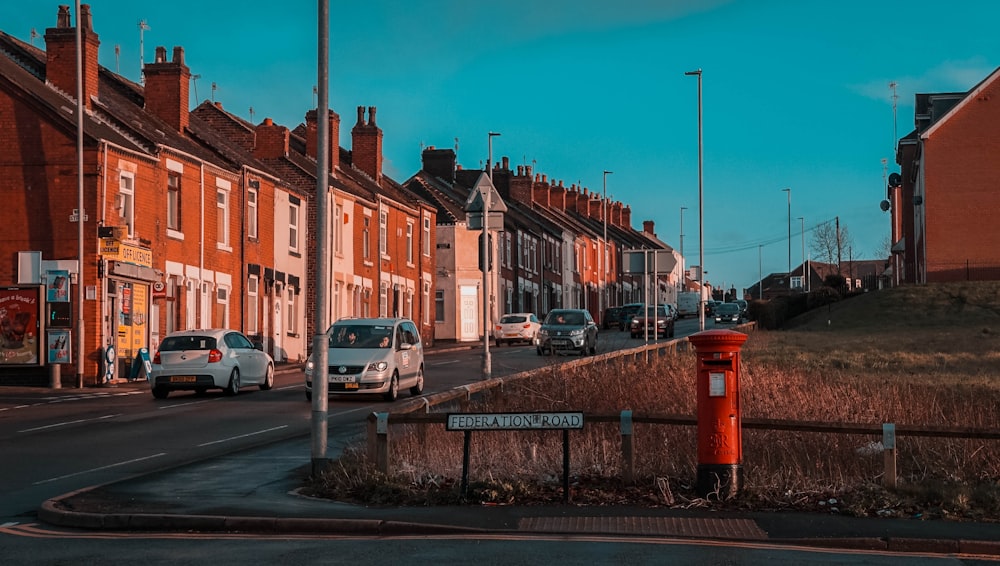 cars parked on side of road near buildings during daytime