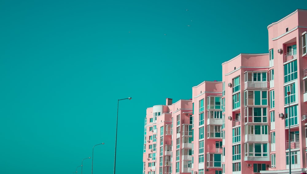 white and green concrete building under blue sky during daytime