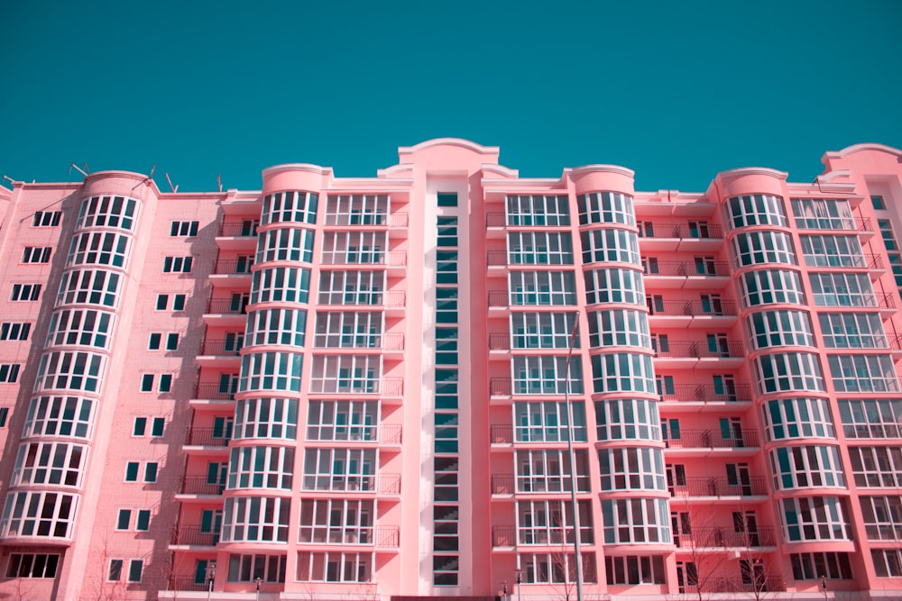 pink and white concrete building under blue sky during daytime