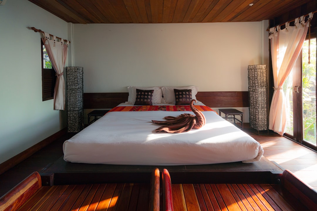 white bed linen on bed, Bungalow room in cozy boutique hotel in Thailand