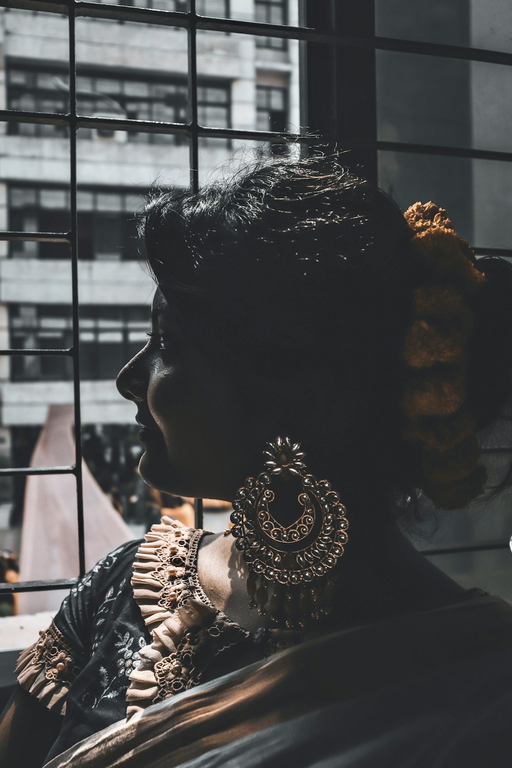 woman in gold and silver earrings