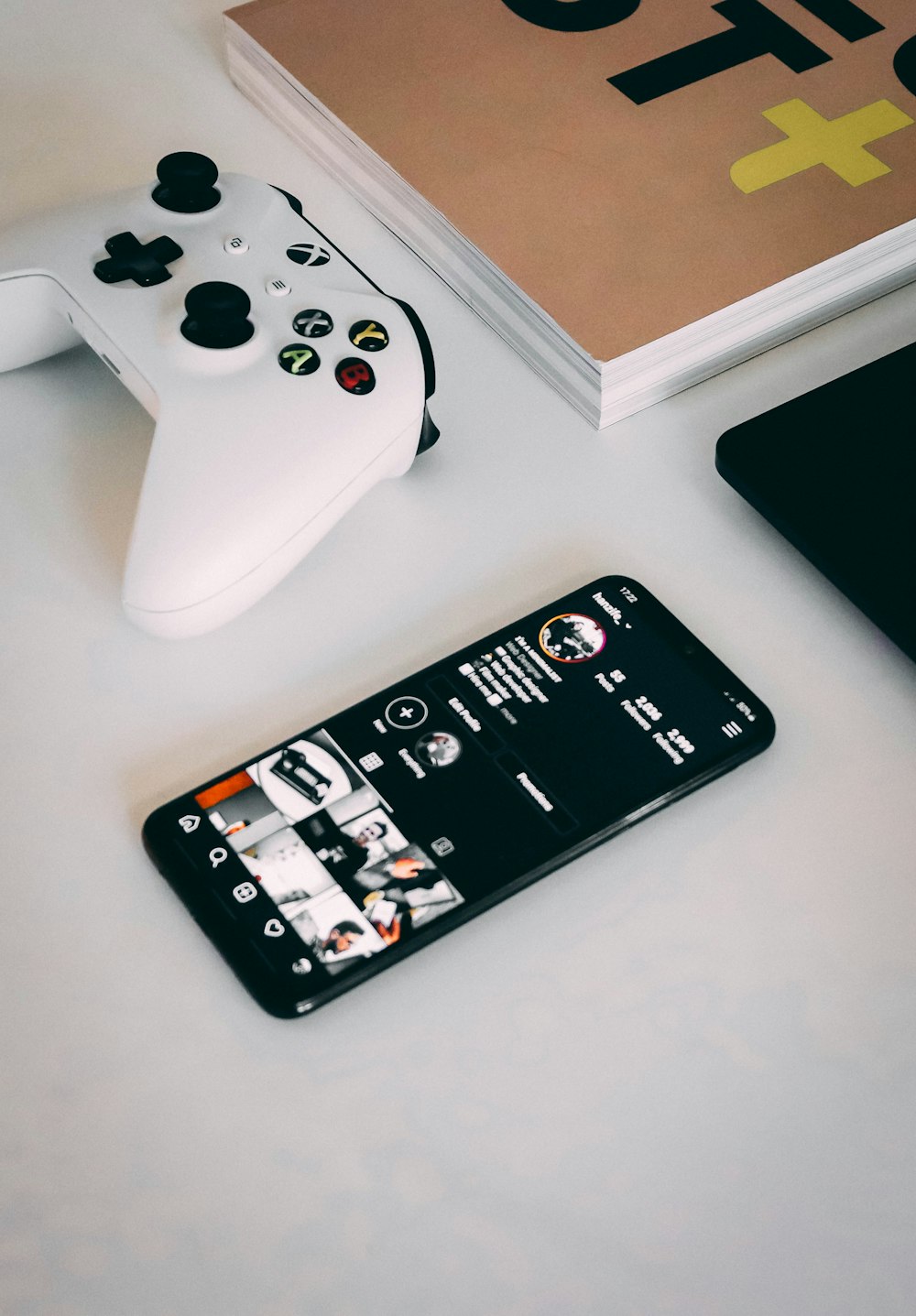 white sony ps 4 controller beside white xbox one controller