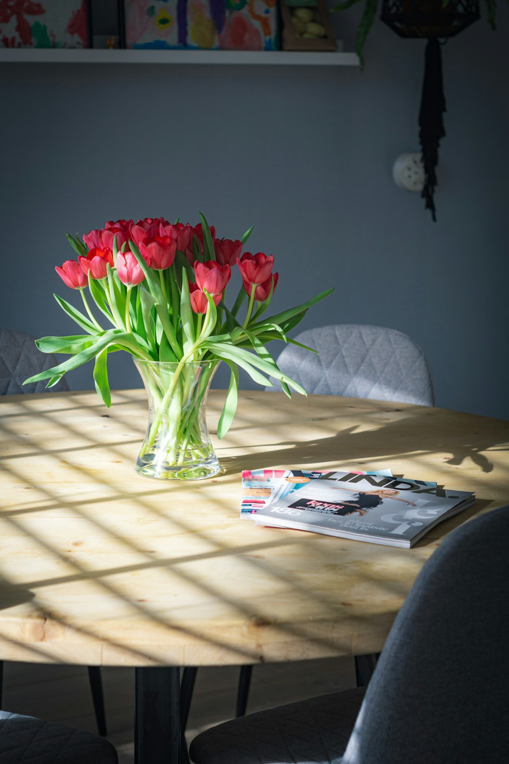 red and pink flowers in clear glass vase