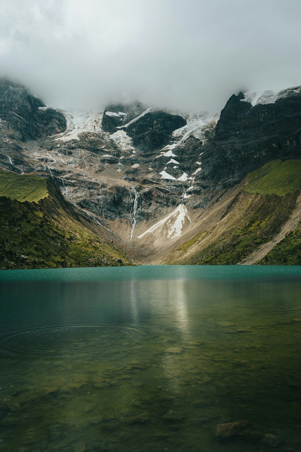 lake near mountain range during daytime