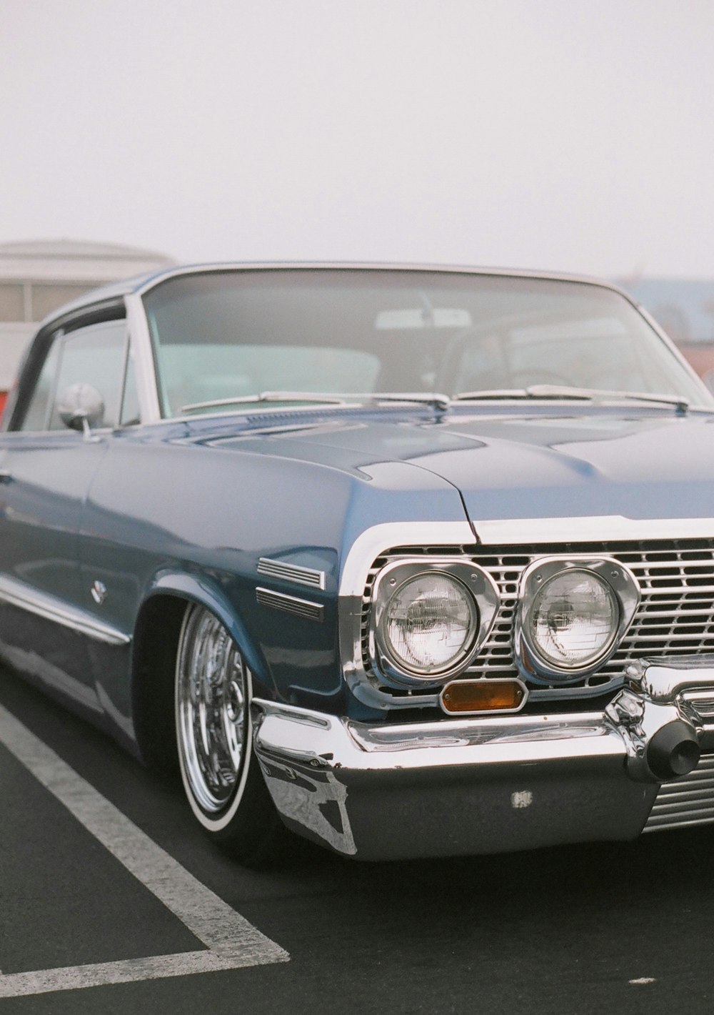 blue classic car on road during daytime