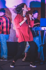 man in red jacket standing beside woman in red coat