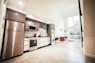 brown wooden kitchen cabinet near white wall