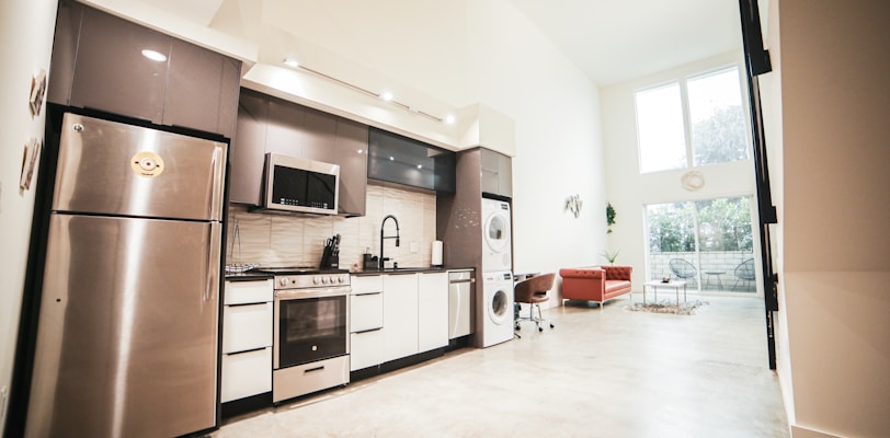 brown wooden kitchen cabinet near white wall