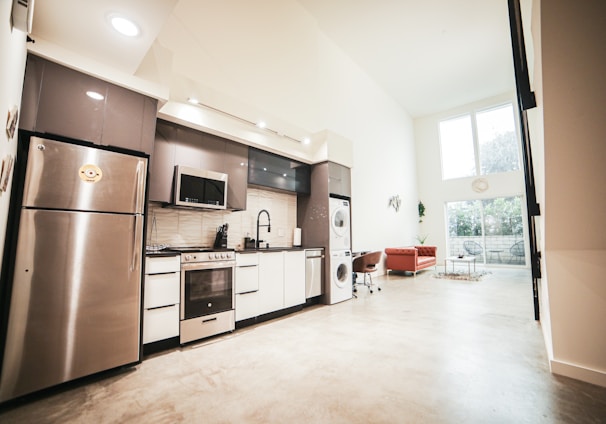 brown wooden kitchen cabinet near white wall