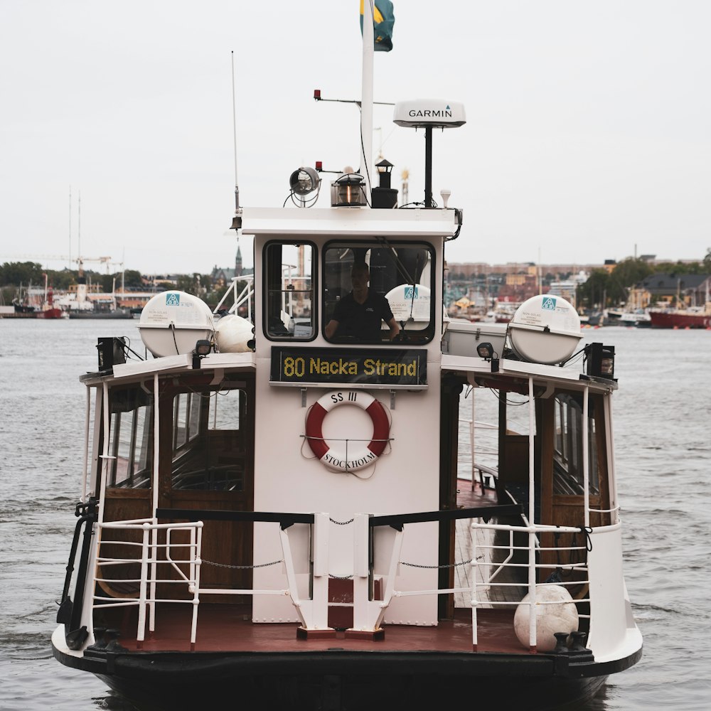 red and white boat on sea during daytime