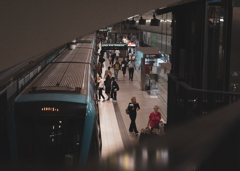 people walking on sidewalk during night time