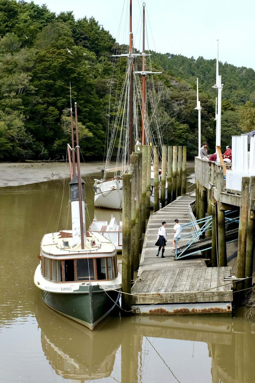 white and blue boat on dock during daytime