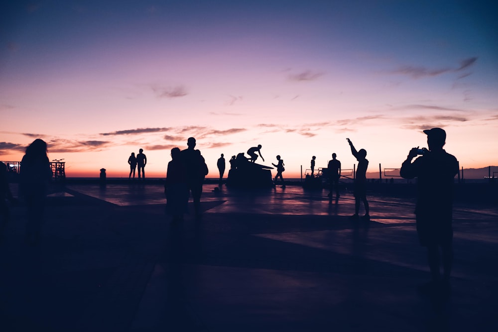 silhouette of people on beach during sunset