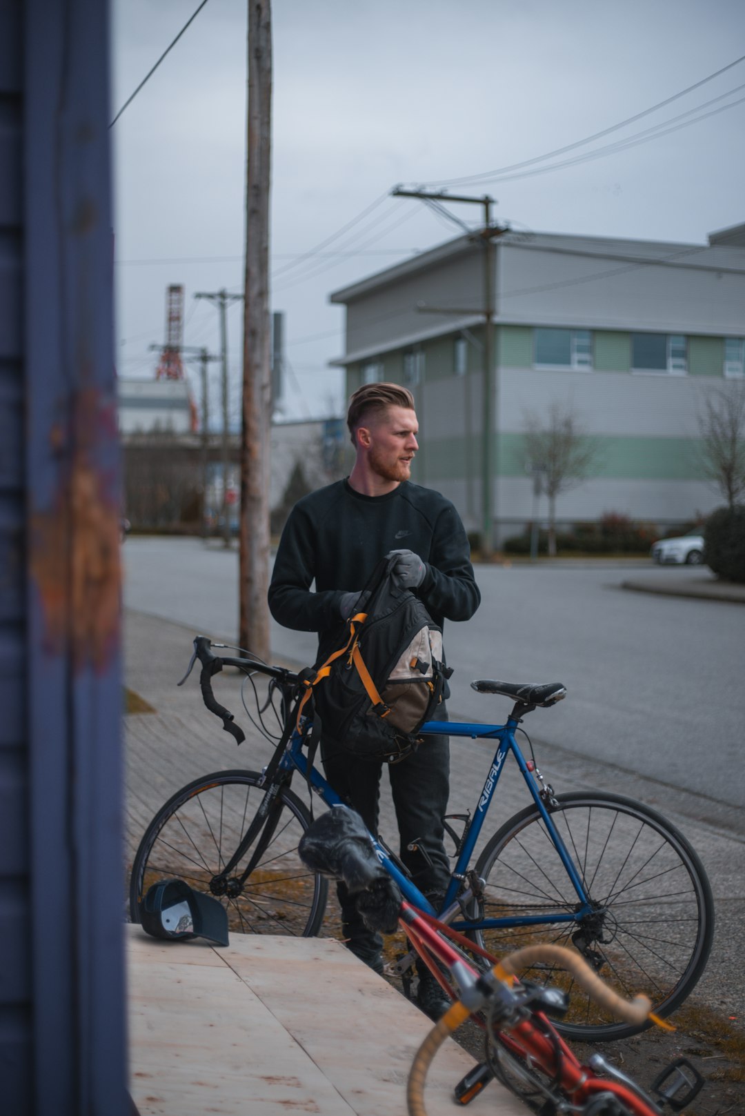 man in black jacket riding on bicycle during daytime