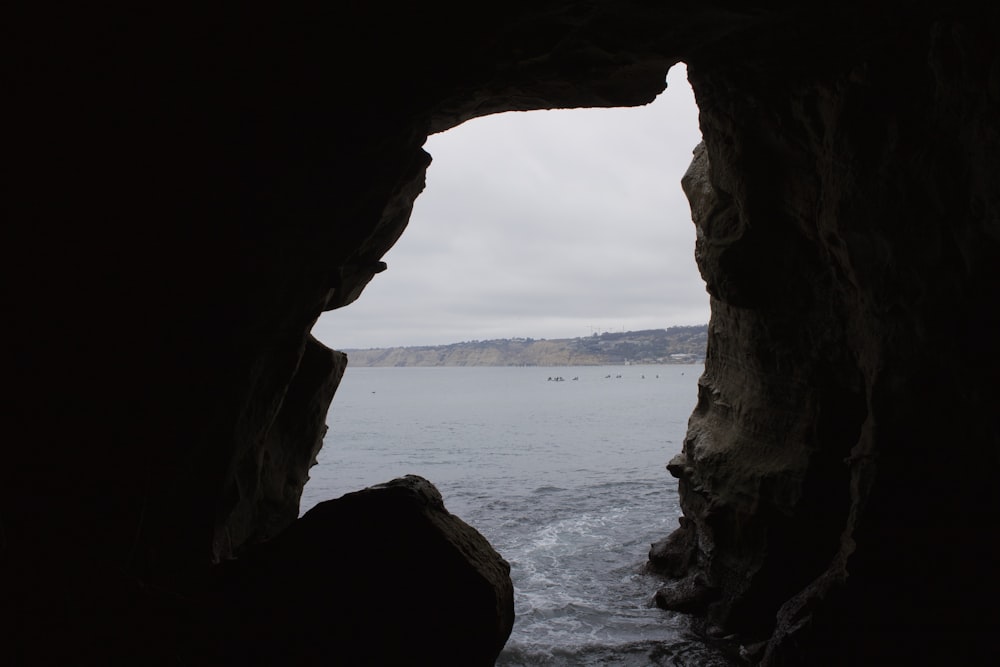 brown rock formation near body of water during daytime