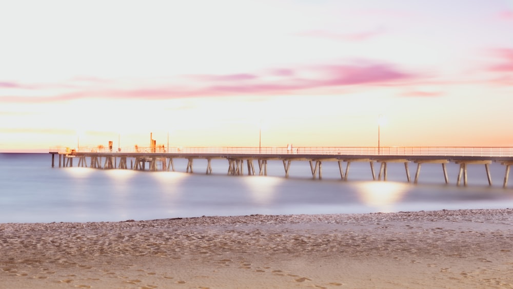 bridge over the sea during sunset